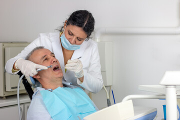 Open mouth during drilling treatment at the dentist in dental clinic