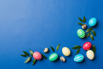 Colorful Easter eggs with spring flower leaf isolated over white background. Colored Egg Holiday border