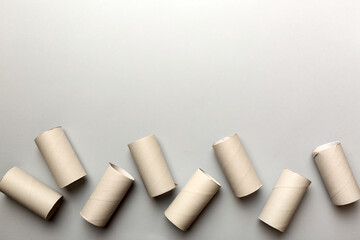 Flat lay composition with empty toilet paper rolls and space for text on color background. Recyclable paper tube with metal plug end made of kraft paper or cardboard