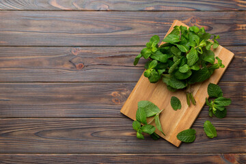 Fresh mint on Cutting board table, top view. Flat lay Space for text