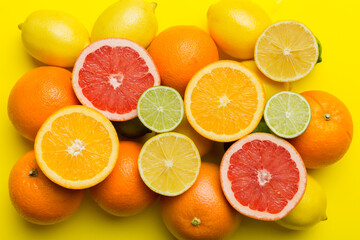 Flat lay of citrus fruits like lime, orange and lemon with lemon tree leaves on light colored background. Space for text healthy concept. Top view