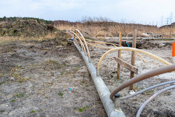 Wellpoint installation to get rid of high groundwater, visible metal and plastic pipes.