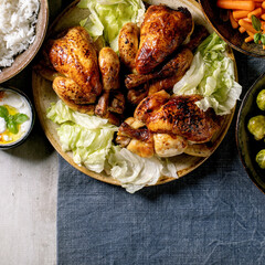 Dinner table with grilled chicken, rice and vegetables