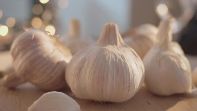 Whole garlic bulbs and cloves ready for use in aromatic traditional cuisine, close-up shot.