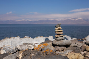 Fototapeta na wymiar Zen style balanced stones on beach. Rock sculpture stone stacking.