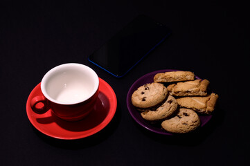 Chocolate Chip Cookies with Cup of Coffee on white fabric