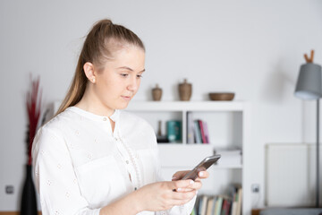 Young woman looking to her phone in the office