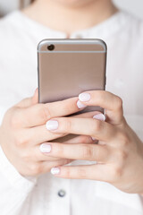 Closeup of female hands holding smartphone