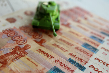 toy tank on the russian banknotes 5000 roubles crisis risk sanctions war conflict russia ukraine...