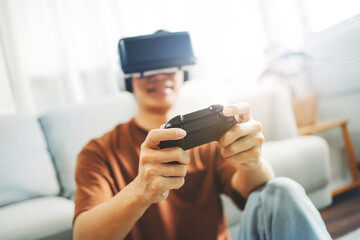 Young man wearing virtual reality goggles at bedroom, VR innovation technology