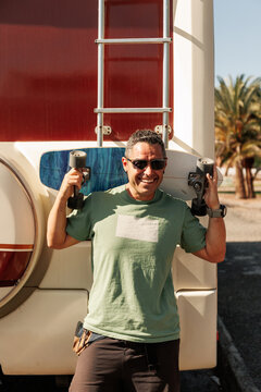 Men skater near to his camper van in Gran Canaria.