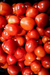 Red cherry tomatoes top down view on vegetable showcase