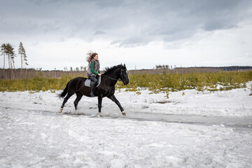girl rides a horse. Walk with a horse through the countryside. fast jump