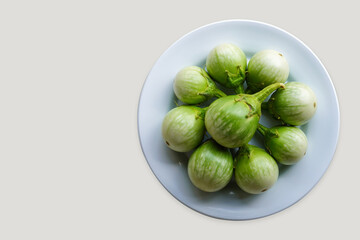 top view fresh nine solanum melongena vegetable on white dish on white background, vegetable,...
