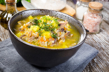 Polish barley soup with vegetables and chicken heart.