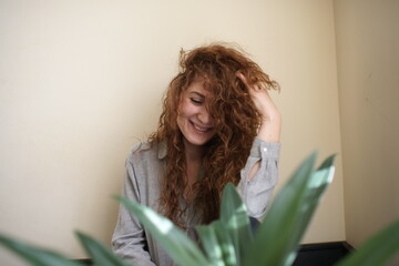 Portrait of a smiling woman. Curly hair. Female. Positive emotions. Facial expression 