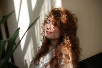 portrait of a woman. Lights and shaddows. Mood. Curly hair 