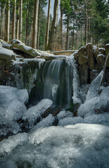 Mountain stream at the turn of winter and spring