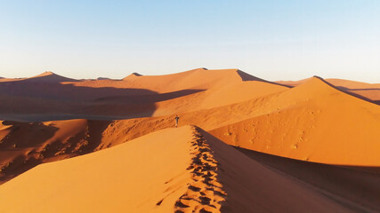 People climbing on the sand dunes
in the Namib Desert, Namibia