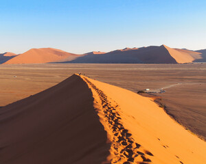 Fototapeta na wymiar People climbing on the sand dunes in the Namib Desert, Namibia