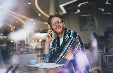 Young caucasian guy working or studying at table