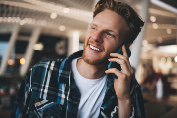 Young caucasian guy talk on smartphone in office