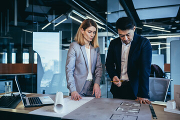 professional architect designer structural engineer team colleagues working office looking computer screen discussing building plan design project draft drawing. team multiracial business developers