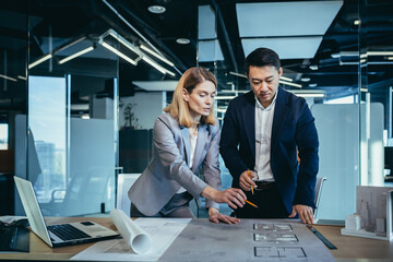 professional architect designer structural engineer team colleagues working office looking computer...