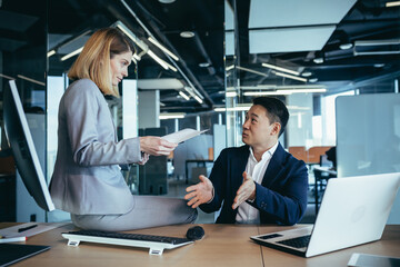 Sexual relationship and flirt at office. Young sensual Business lady seducing her busy male colleague. sexy secretary flirting with boss in the workplace. Business people Asian man and woman in work