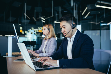 Happy call center employee communicates with customers, advises on video call, remotely, asian...