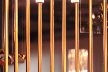 Close-up golden bars of the lattice.