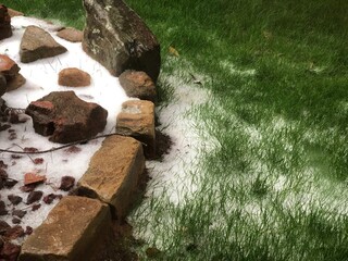 Fresh snow flurries on a landscaped backyard, cropped shot