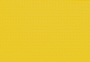 Porous yellow background from a kitchen sponge. Yellow background made of soft synthetic material with a chaotic close-up of pores. Free space for ads and text