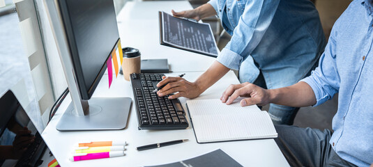 Two professional programmer cooperating and working on web site project in a software developing on...