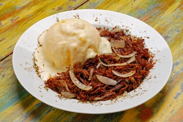 Brazilian couscous with melted cheese and shredded sun-dried meat. Typical dish from northeast Brazil.