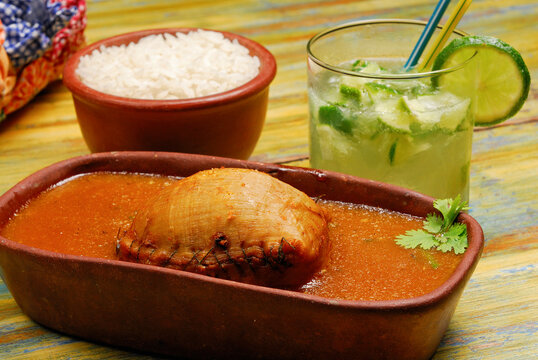 Buchada goat, made with goat viscera is a typical dish from northeastern Brazil. Accompanied with a caipirinha drink.
