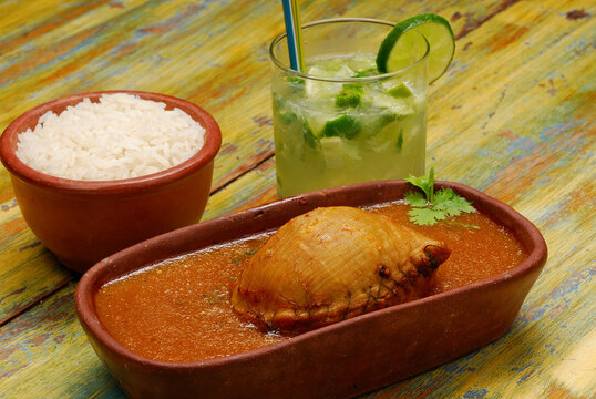 Buchada goat, made with goat viscera is a typical dish from northeastern Brazil. Accompanied with a caipirinha drink.