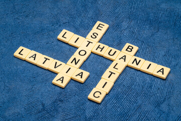Baltic states, Latvia, Estonia and Lithuania, crossword in ivory letter tiles against textured handmade paper
