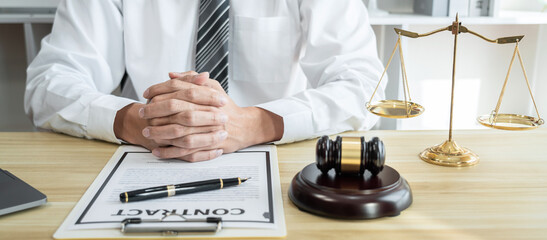 Male lawyer working with litigation contract paper documents of the estate lawsuit, Law books and...