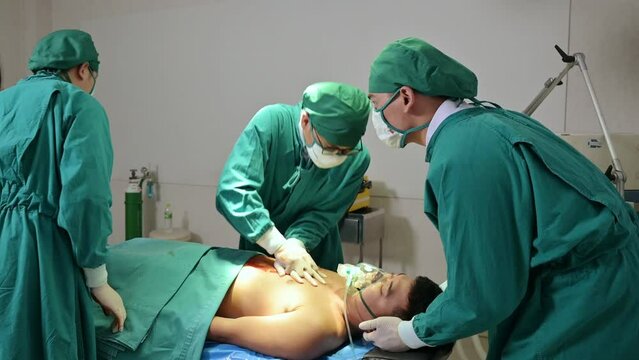 Team of doctor and assistant helping by CPR with accident injured patient unresponsive in operating room