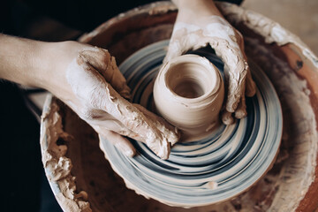 Potter makes a clay product. Close-up of hands