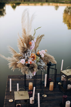 Wedding bouquet in boho style. Wedding decor on the pier