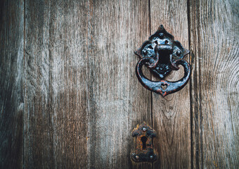 Doorknob and keyhole are on vintage wooden door