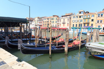 Fototapeta na wymiar Gondolas mooring at Grand Canal in Venice, Italy