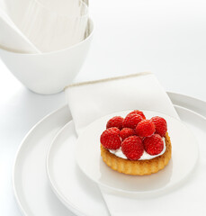 Raspberry cake with cream cheese on white background.