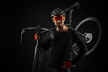 male cyclist with road bicycle on black background