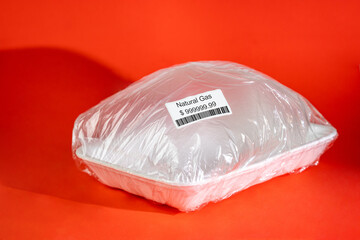 Natural gas sale concept. Expensive gas price. Creative image. Transparent plastic container with...
