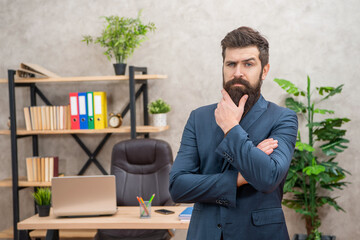 confident bearded boss wear suit in the office with copy space, business