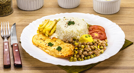 homemade brazilian food, rice and beans, salad, farofa and fried chicken fillet, traditional brazilian meal or lunch
