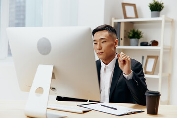 manager sitting at a desk in front of a computer emotions Workspace